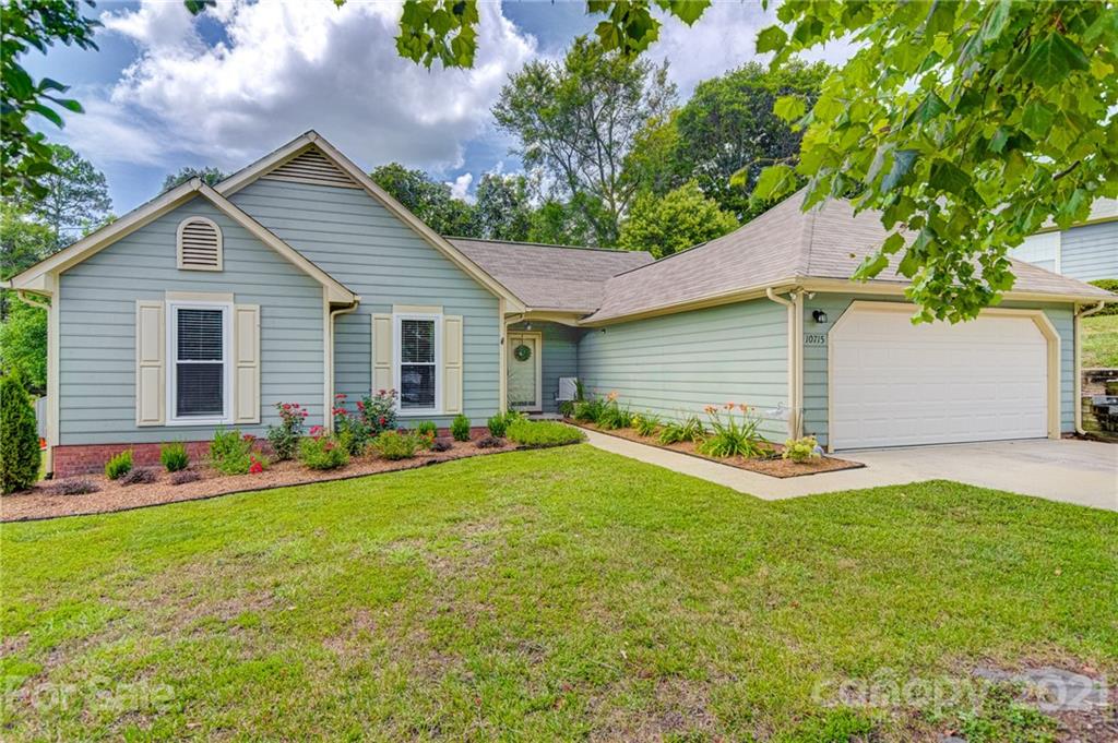 a front view of house with yard and green space