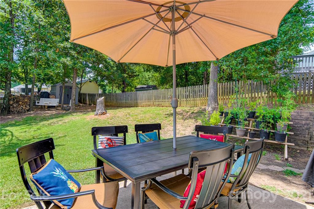 10715 Spruce Mountain Road Charlotte, NC 28214 - Photo 12 of 33 a view of an outdoor sitting area with furniture and umbrella