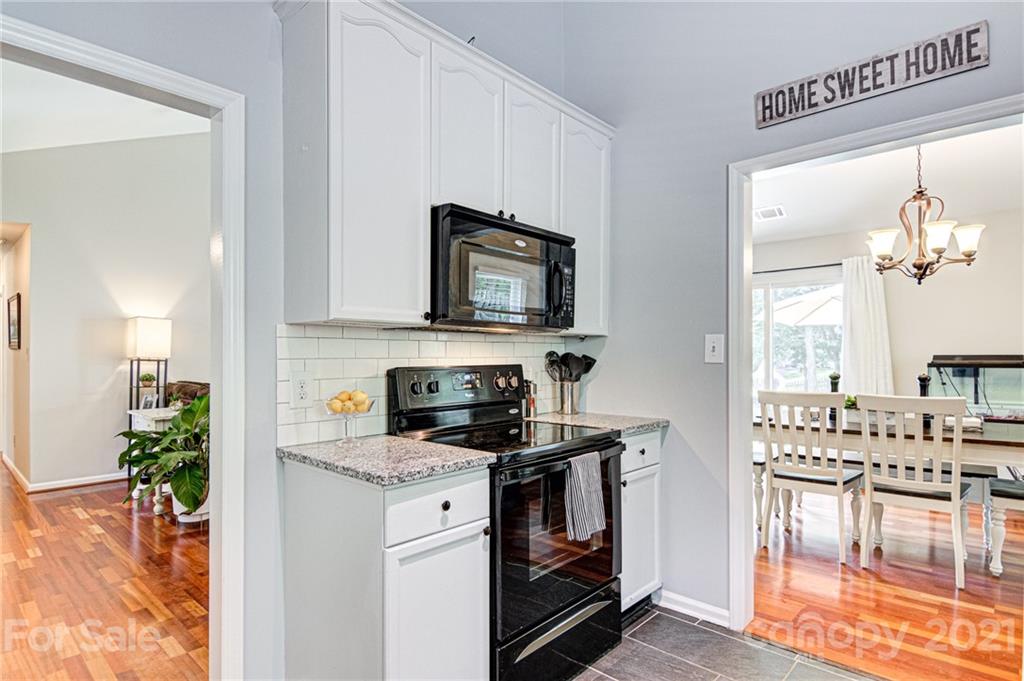 10715 Spruce Mountain Road Charlotte, NC 28214 - Photo 14 of 33 a kitchen with a stove a sink and a microwave
