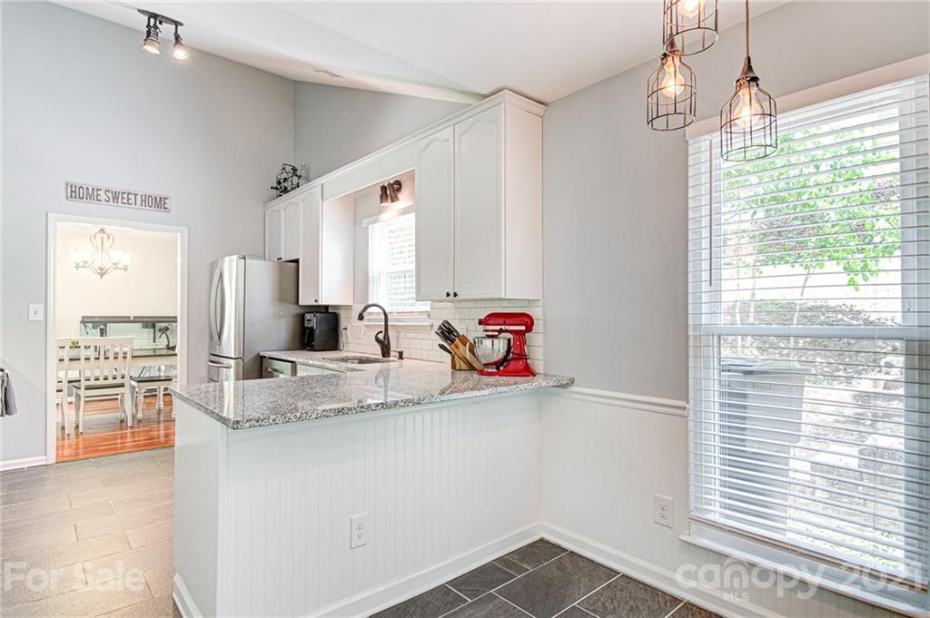 10715 Spruce Mountain Road Charlotte, NC 28214 - Photo 16 of 33 a kitchen with stainless steel appliances granite countertop a sink window and cabinets