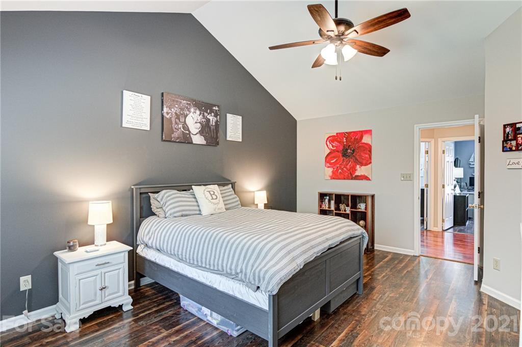 10715 Spruce Mountain Road Charlotte, NC 28214 - Photo 19 of 33 a bedroom with a bed and a chandelier