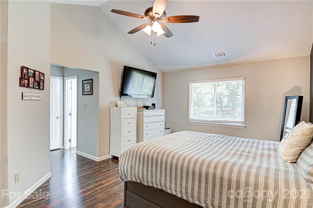 10715 Spruce Mountain Road Charlotte, NC 28214 - Photo 20 of 33 a bedroom with a bed and a flat screen tv