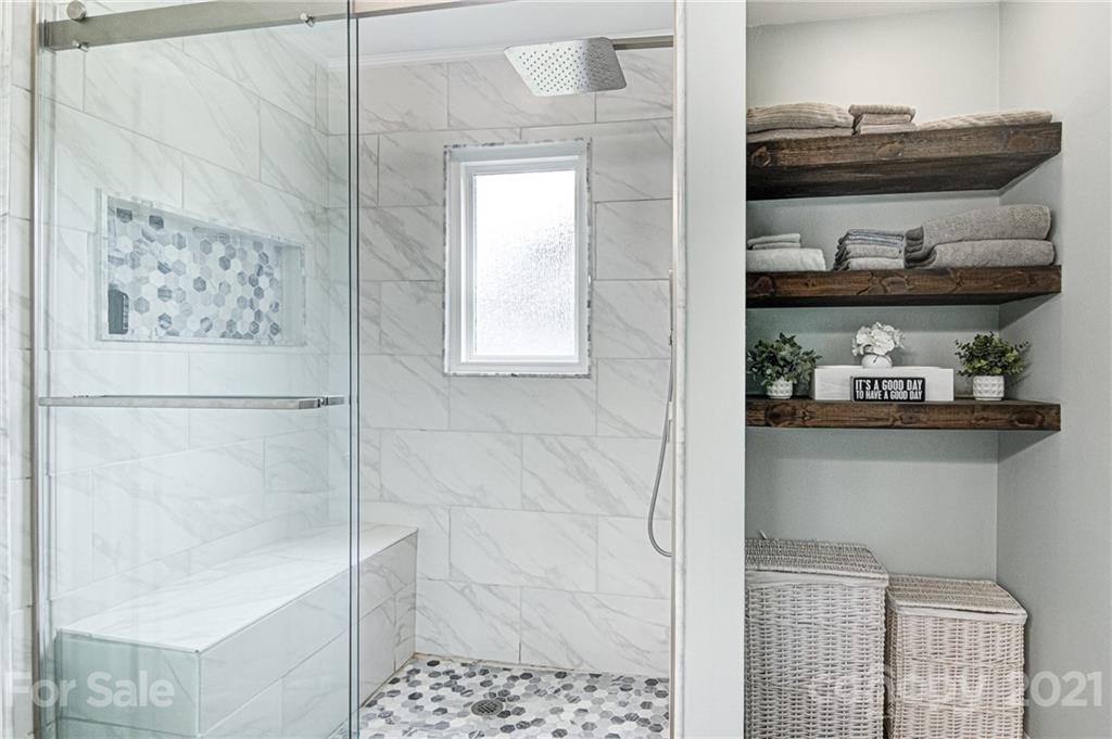10715 Spruce Mountain Road Charlotte, NC 28214 - Photo 22 of 33 a bathroom with a bathtub and a window