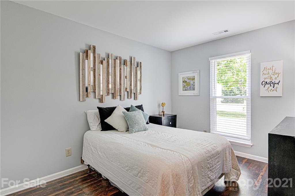 10715 Spruce Mountain Road Charlotte, NC 28214 - Photo 23 of 33 a bedroom with a bed and a tv