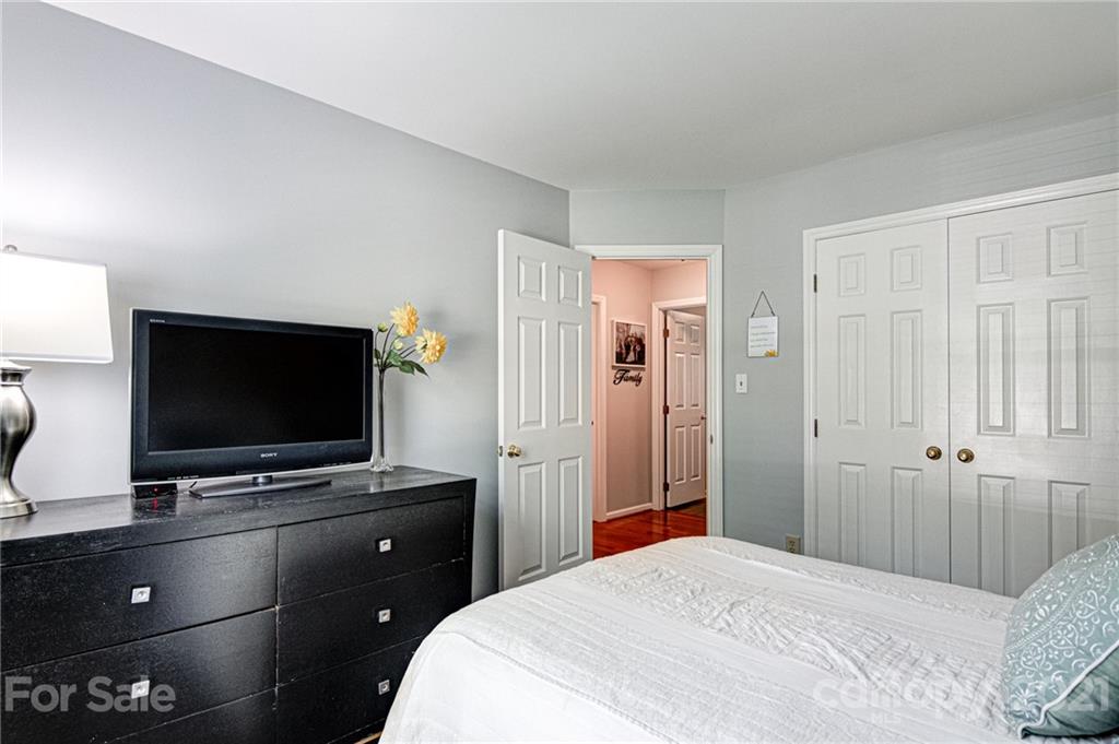 10715 Spruce Mountain Road Charlotte, NC 28214 - Photo 24 of 33 a bedroom with a bed and a flat screen tv