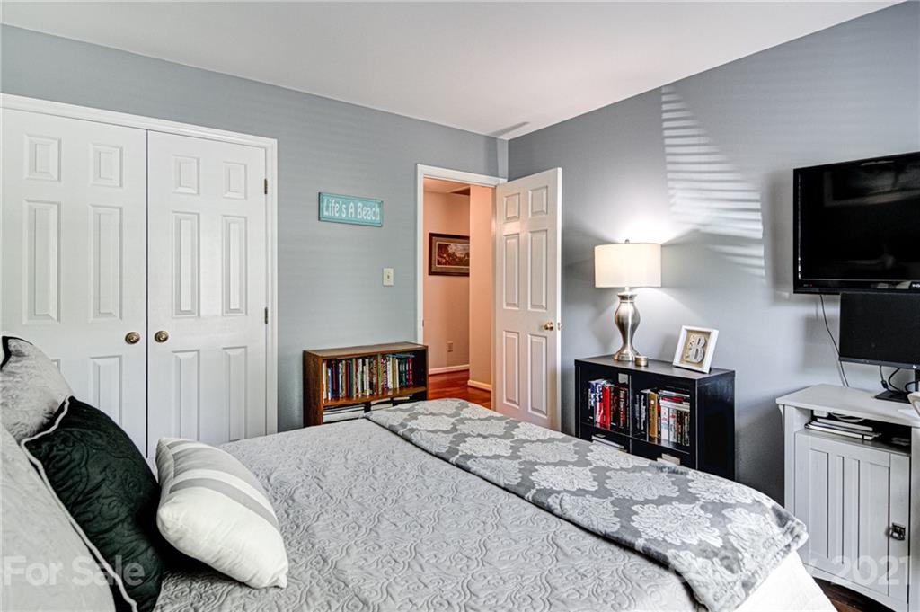 10715 Spruce Mountain Road Charlotte, NC 28214 - Photo 26 of 33 a bedroom with a bed and a flat screen tv