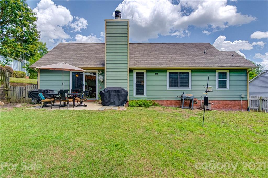 10715 Spruce Mountain Road Charlotte, NC 28214 - Photo 28 of 33 a backyard of a house with table and chairs