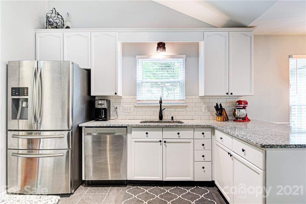 10715 Spruce Mountain Road Charlotte, NC 28214 - Photo 4 of 33 a kitchen with granite countertop white cabinets white stainless steel appliances and a sink