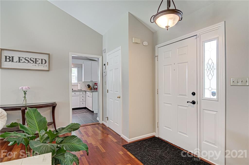 10715 Spruce Mountain Road Charlotte, NC 28214 - Photo 5 of 33 a view of a hallway with wooden floor and a bathroom