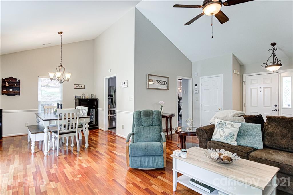 10715 Spruce Mountain Road Charlotte, NC 28214 - Photo 9 of 33 a living room with furniture wooden floor and a chandelier
