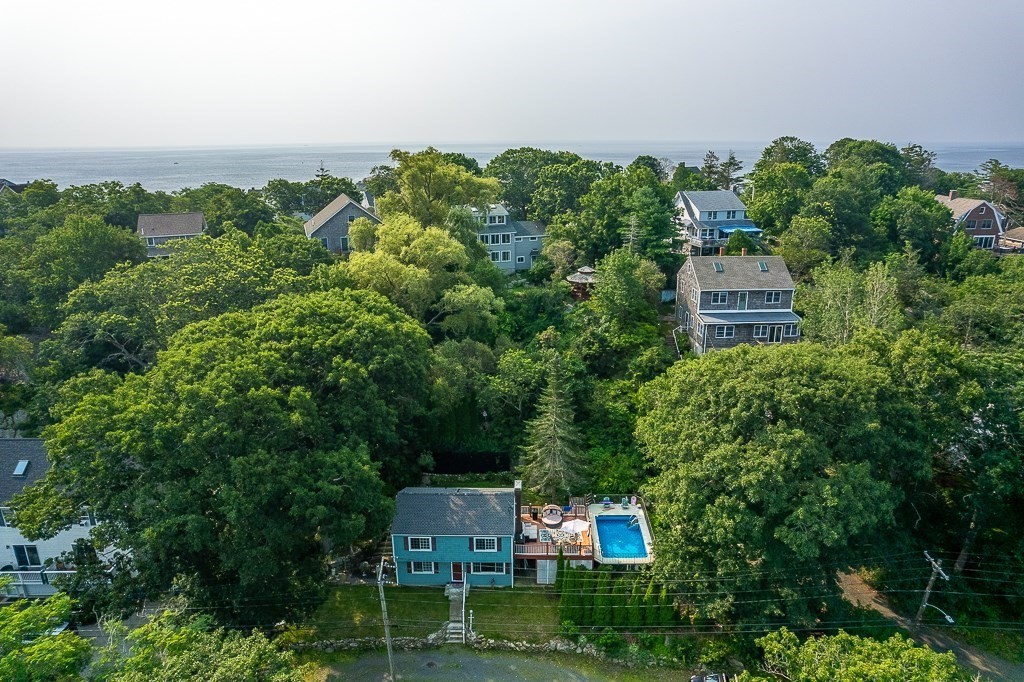 an aerial view of a house with yard and outdoor seating