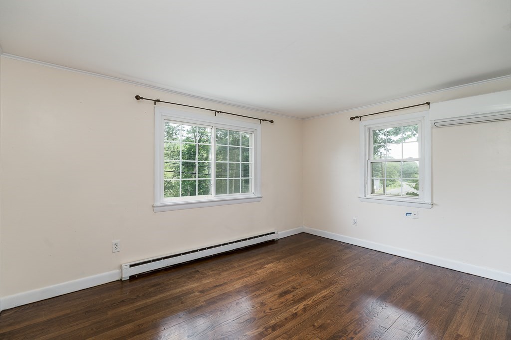 133 Thatcher Road Gloucester, MA 01930 - Photo 14 of 32 an empty room with wooden floor and windows