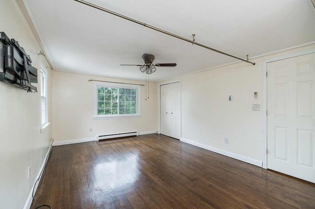 133 Thatcher Road Gloucester, MA 01930 - Photo 15 of 32 a view of an empty room with wooden floor and a window