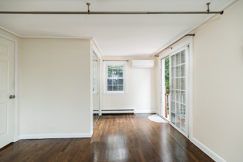 133 Thatcher Road Gloucester, MA 01930 - Photo 16 of 32 an empty room with wooden floor and windows
