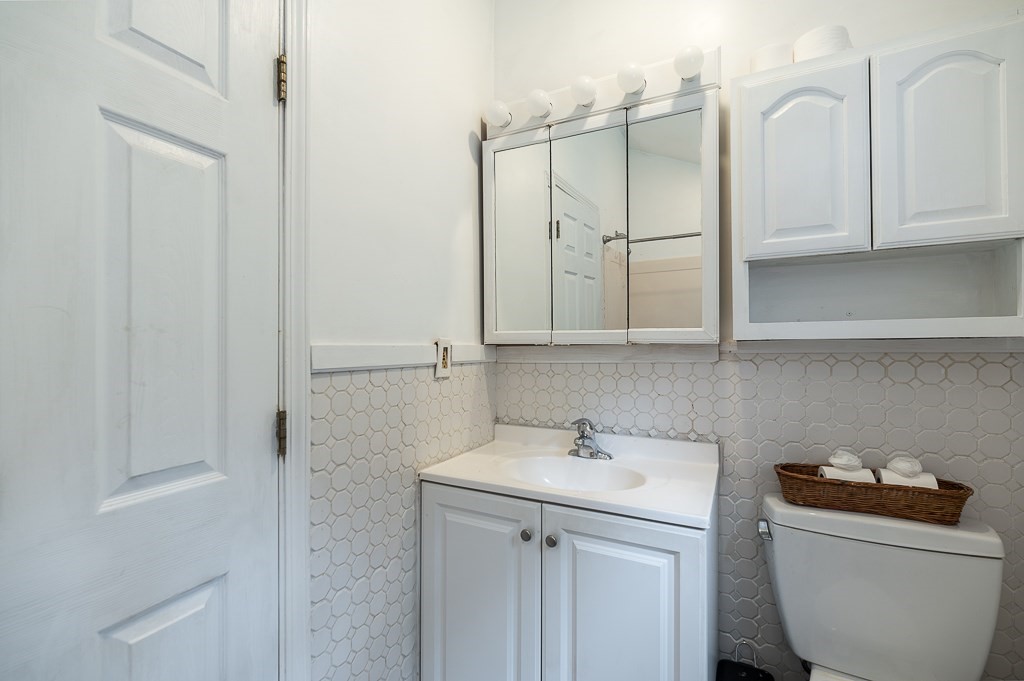 133 Thatcher Road Gloucester, MA 01930 - Photo 17 of 32 a bathroom with a sink and a mirror