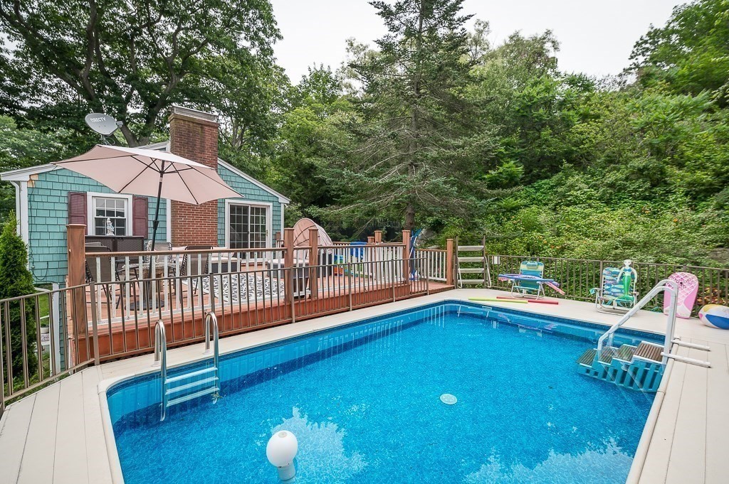 133 Thatcher Road Gloucester, MA 01930 - Photo 23 of 32 a view of a house with a backyard and a patio