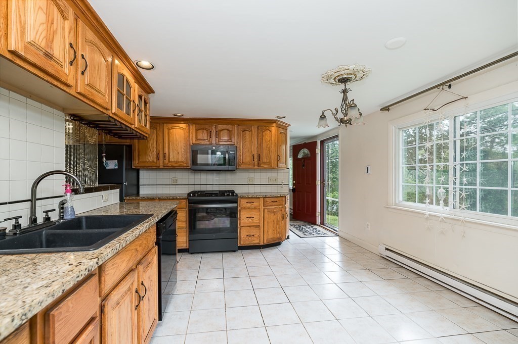 133 Thatcher Road Gloucester, MA 01930 - Photo 10 of 32 a kitchen with stainless steel appliances granite countertop a sink and a stove