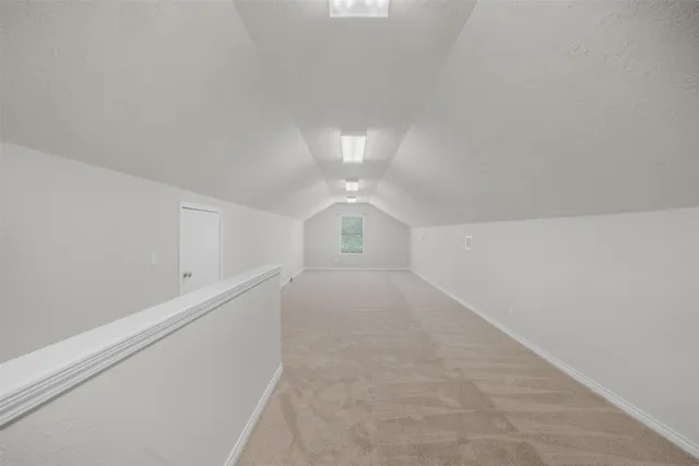 a white toilet sitting next to a white wall