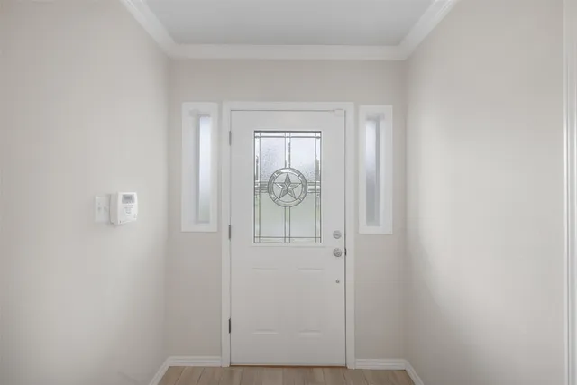 a kitchen with white cabinets a sink dishwasher a stove and a refrigerator with wooden floor