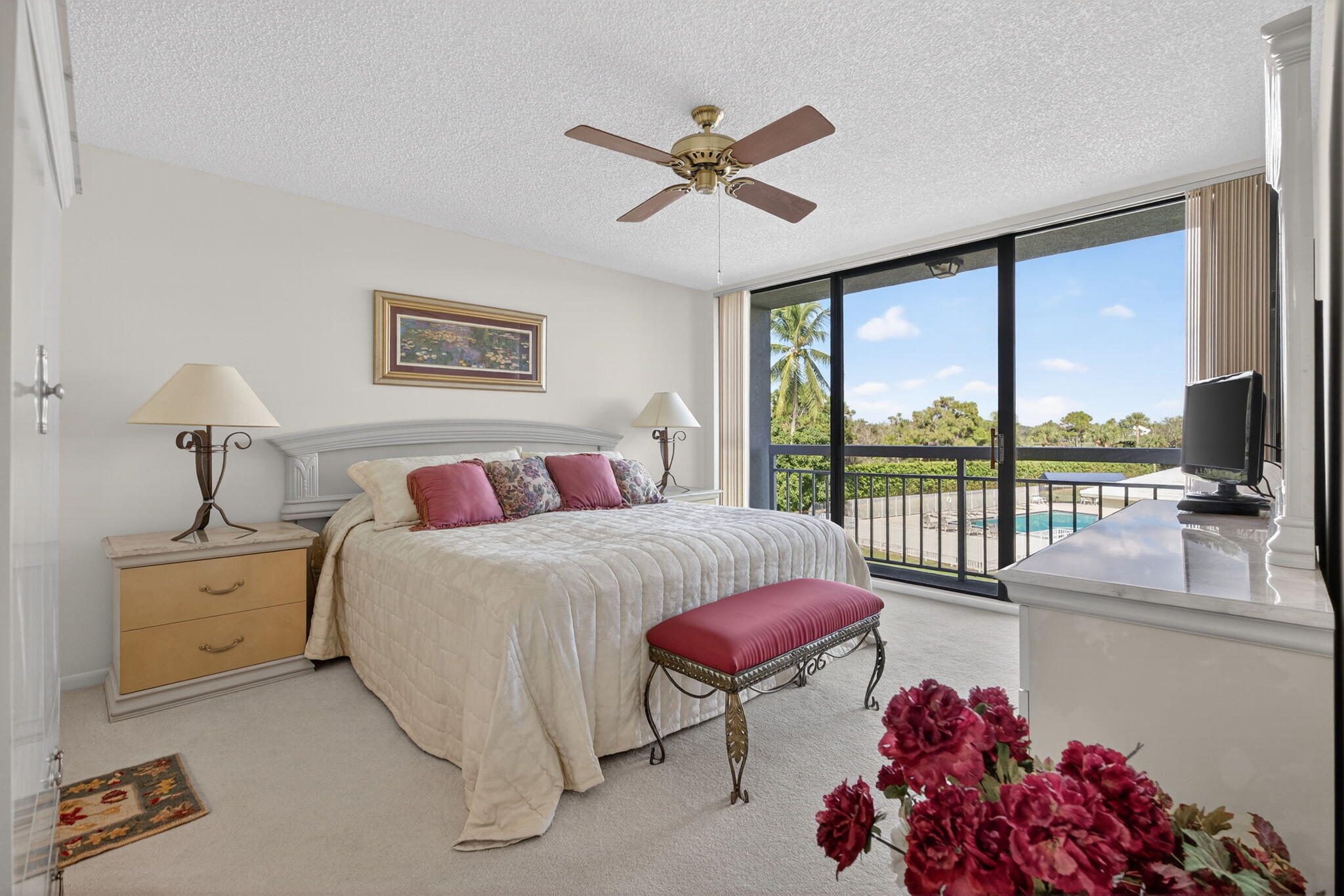 2601 Village Boulevard, Unit 303 West Palm Beach, FL 33409 - Photo 11 of 23 a spacious bedroom with a bed and a chandelier