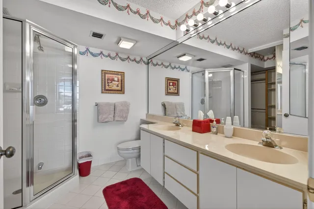 a bathroom with a sink vanity mirror and toilet