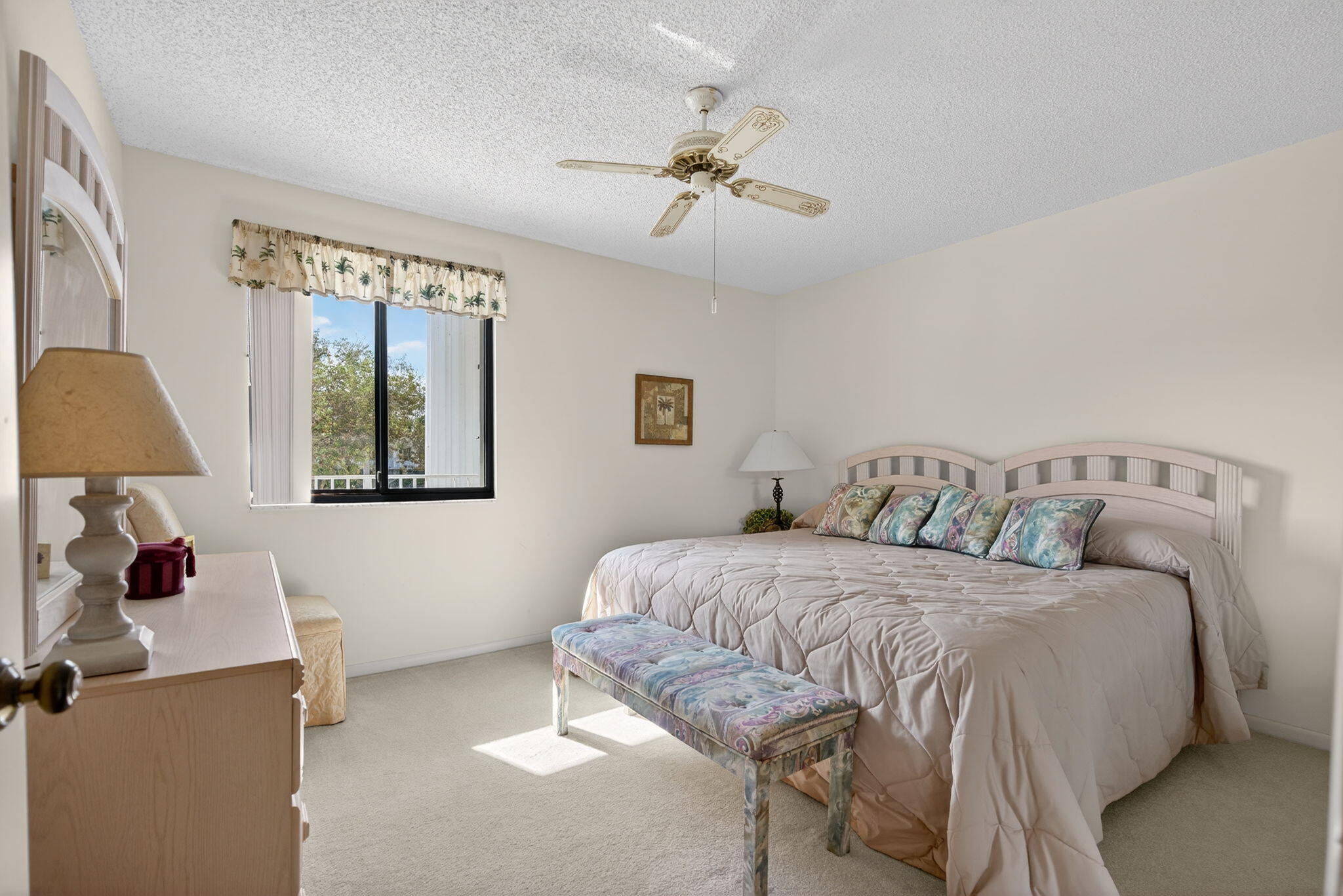 2601 Village Boulevard, Unit 303 West Palm Beach, FL 33409 - Photo 15 of 23 a bedroom with a bed and a chandelier