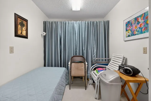 a bedroom with a bed and a painting on the wall