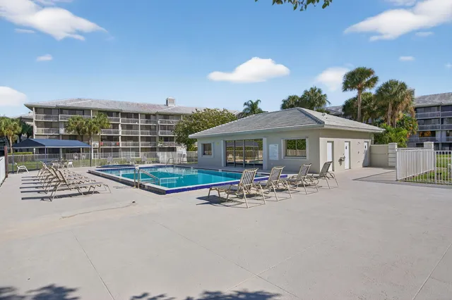 a view of a house with backyard porch and sitting area