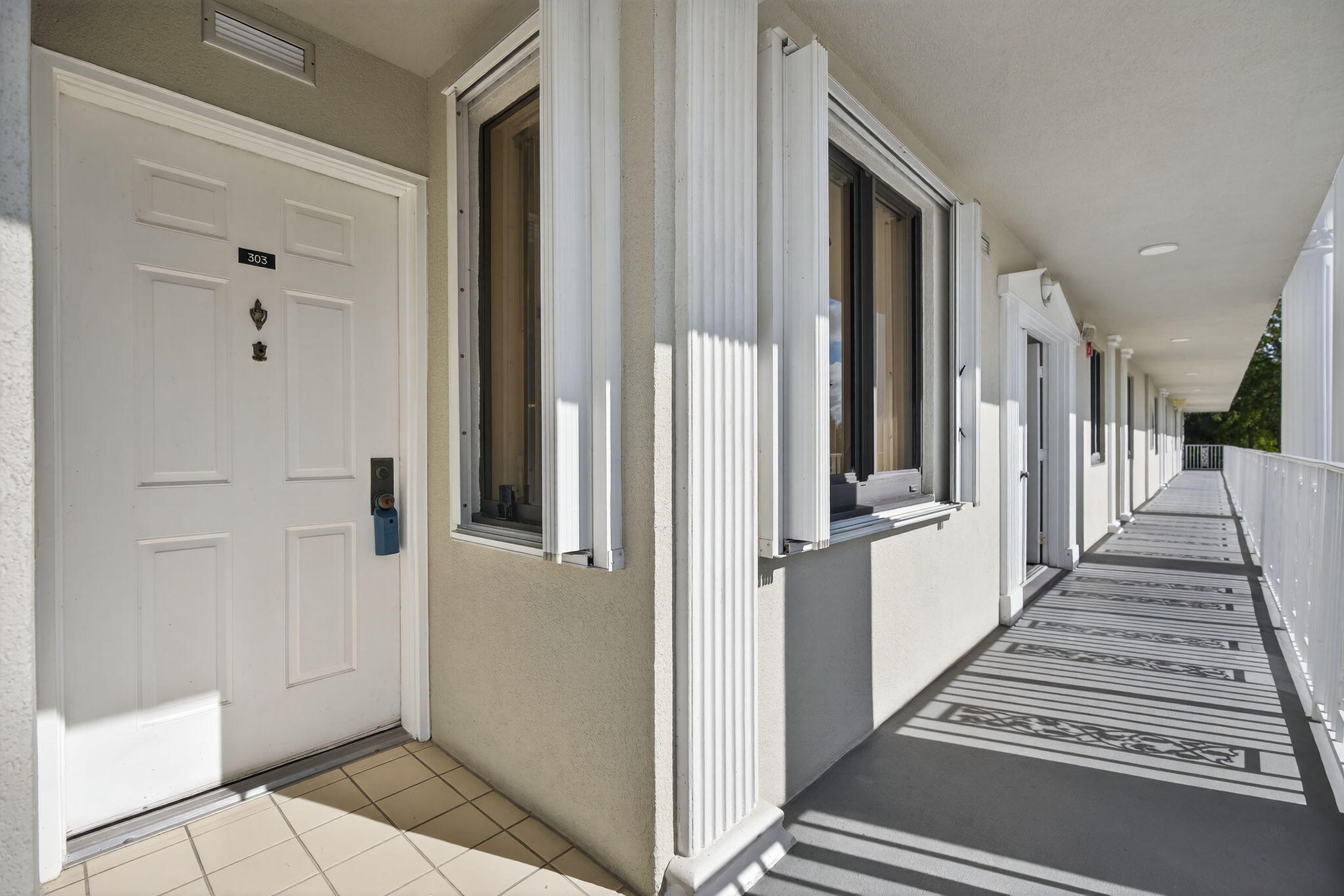 2601 Village Boulevard, Unit 303 West Palm Beach, FL 33409 - Photo 2 of 23 a view of a hallway with wooden floor and staircase