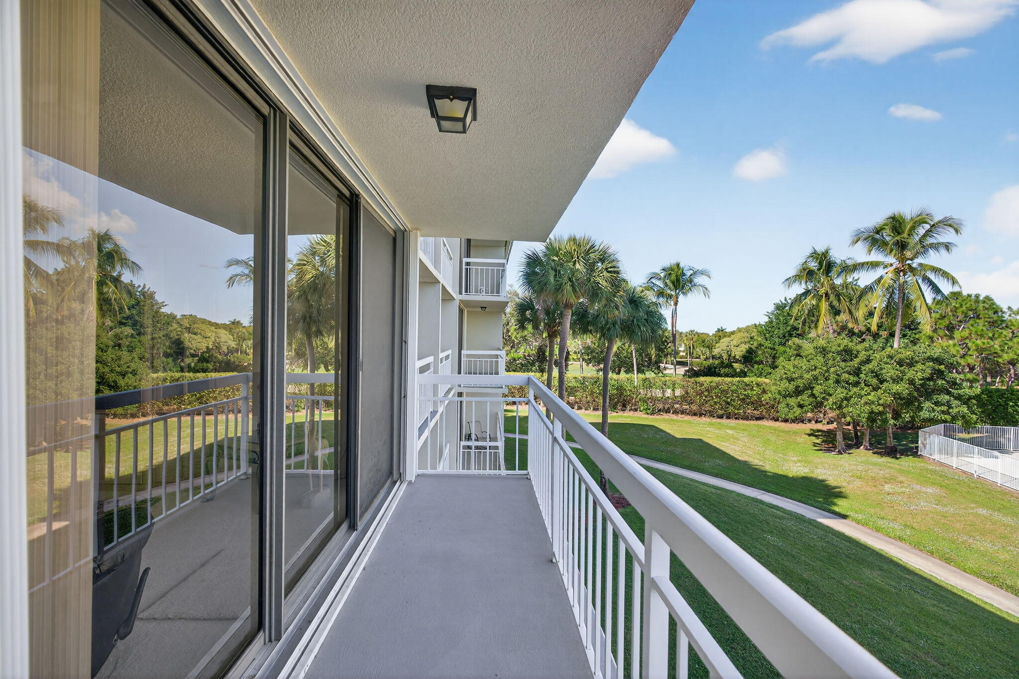 2601 Village Boulevard, Unit 303 West Palm Beach, FL 33409 - Photo 21 of 23 a view of a balcony with yard