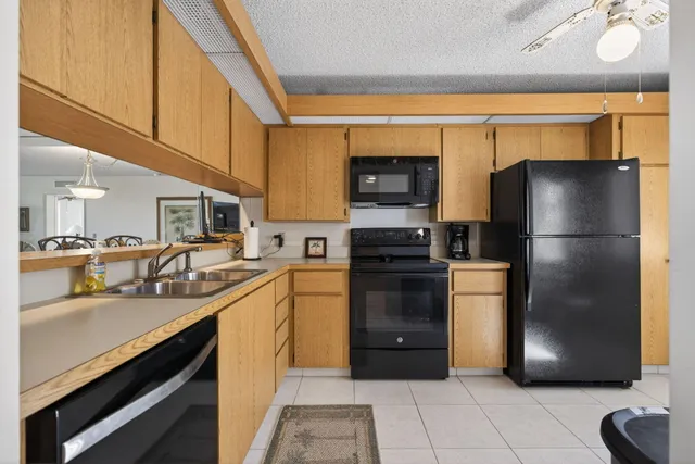 a kitchen with a refrigerator and a sink