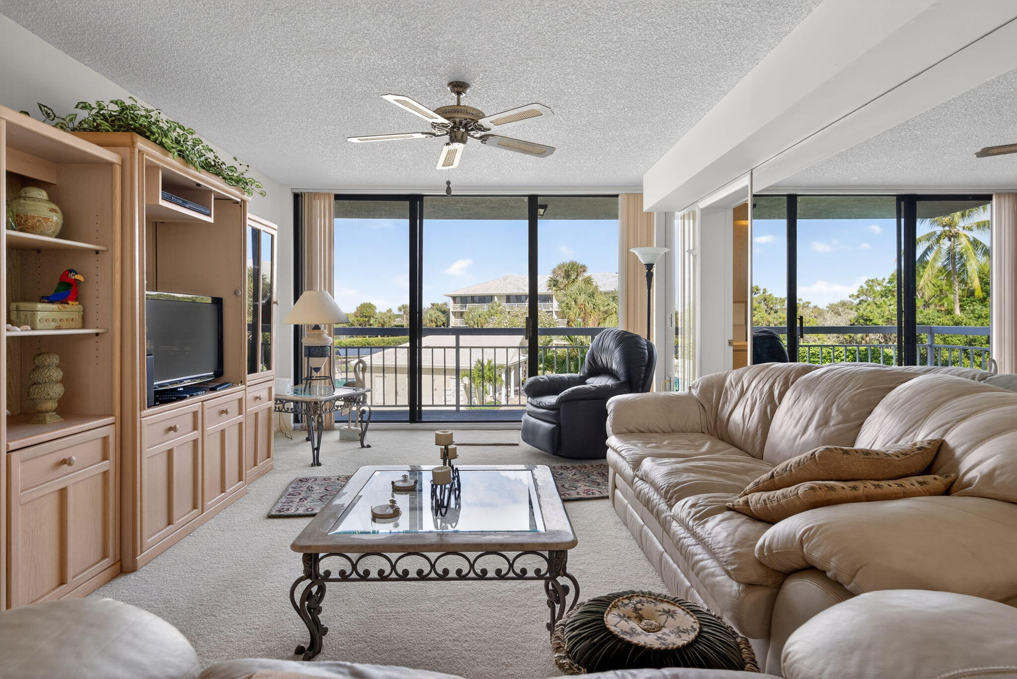 2601 Village Boulevard, Unit 303 West Palm Beach, FL 33409 - Photo 8 of 23 a living room with furniture and a flat screen tv