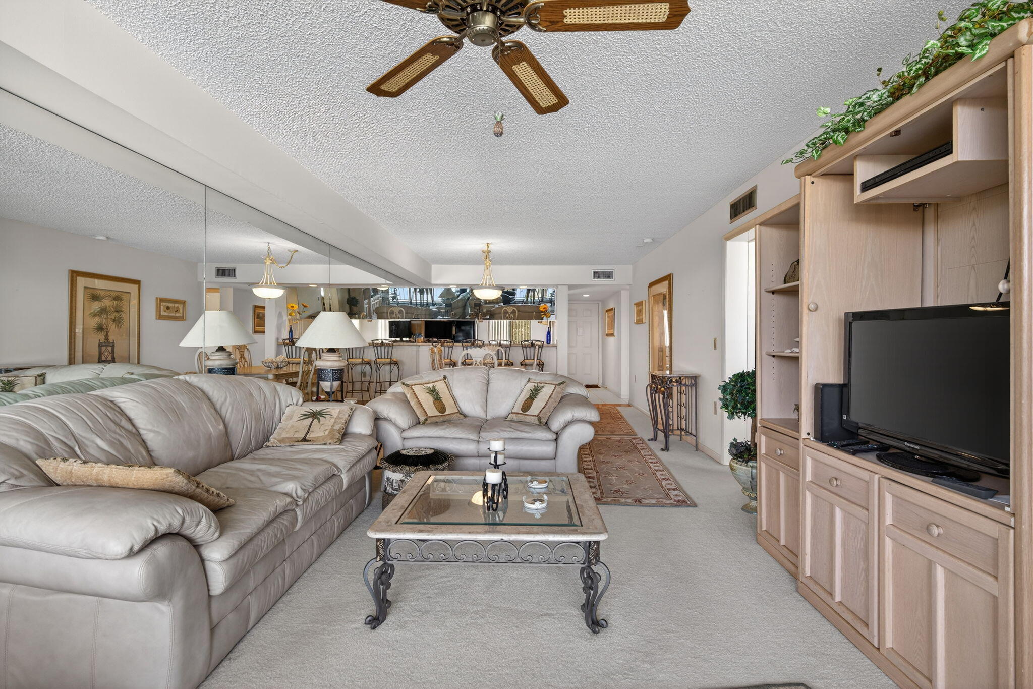 2601 Village Boulevard, Unit 303 West Palm Beach, FL 33409 - Photo 10 of 23 a living room with furniture and a flat screen tv