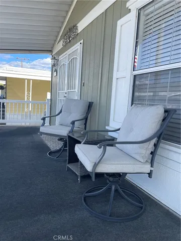 a living room with couches chairs and wooden floor