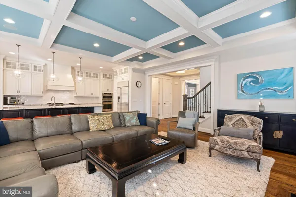 a kitchen with stainless steel appliances a stove top oven a sink dishwasher and a fireplace with wooden floor