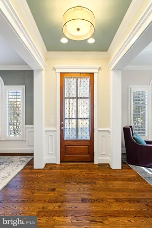a dining room with furniture a chandelier and wooden floor