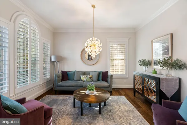 a living room with furniture chandelier and a table