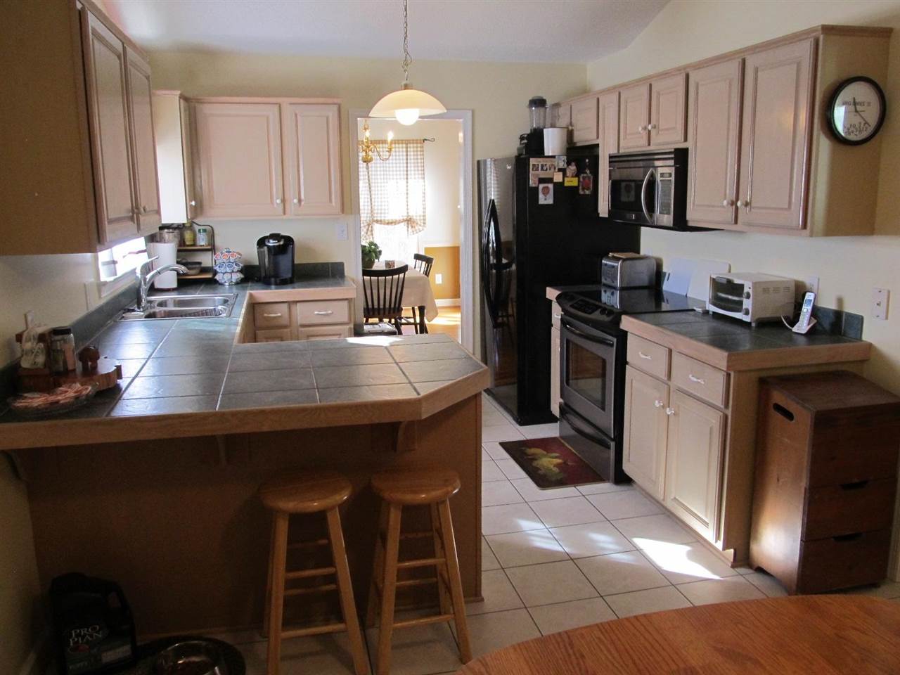 862 Ladd Road Waynesboro, VA 22980 - Photo 7 of 31 a kitchen with a sink a stove a refrigerator cabinets and a dining table