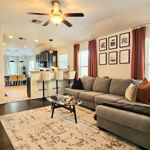 a living room with furniture and a dining table
