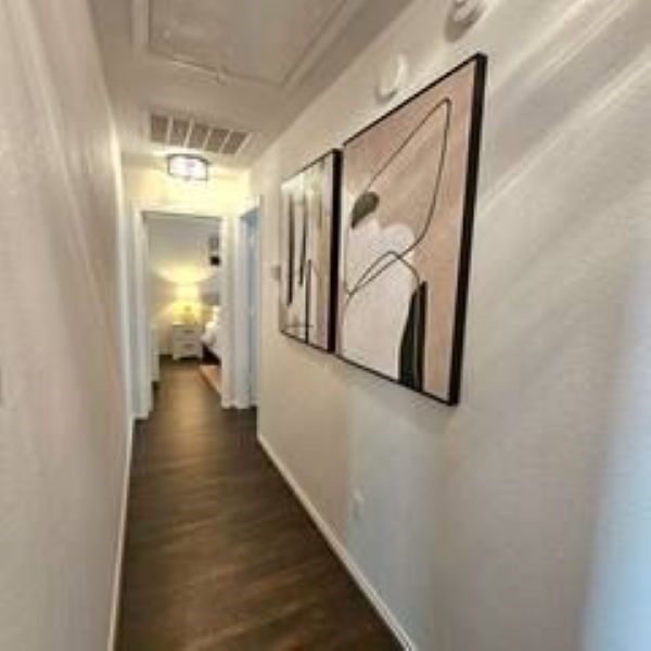 14006 Embrystone Lane Houston, TX 77047 - Photo 7 of 13 a view of a hallway with wooden floor and staircase