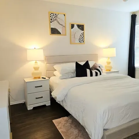 a bedroom with a bed and a night stand