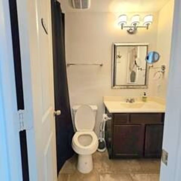 14006 Embrystone Lane Houston, TX 77047 - Photo 10 of 13 a bathroom with a toilet sink and mirror