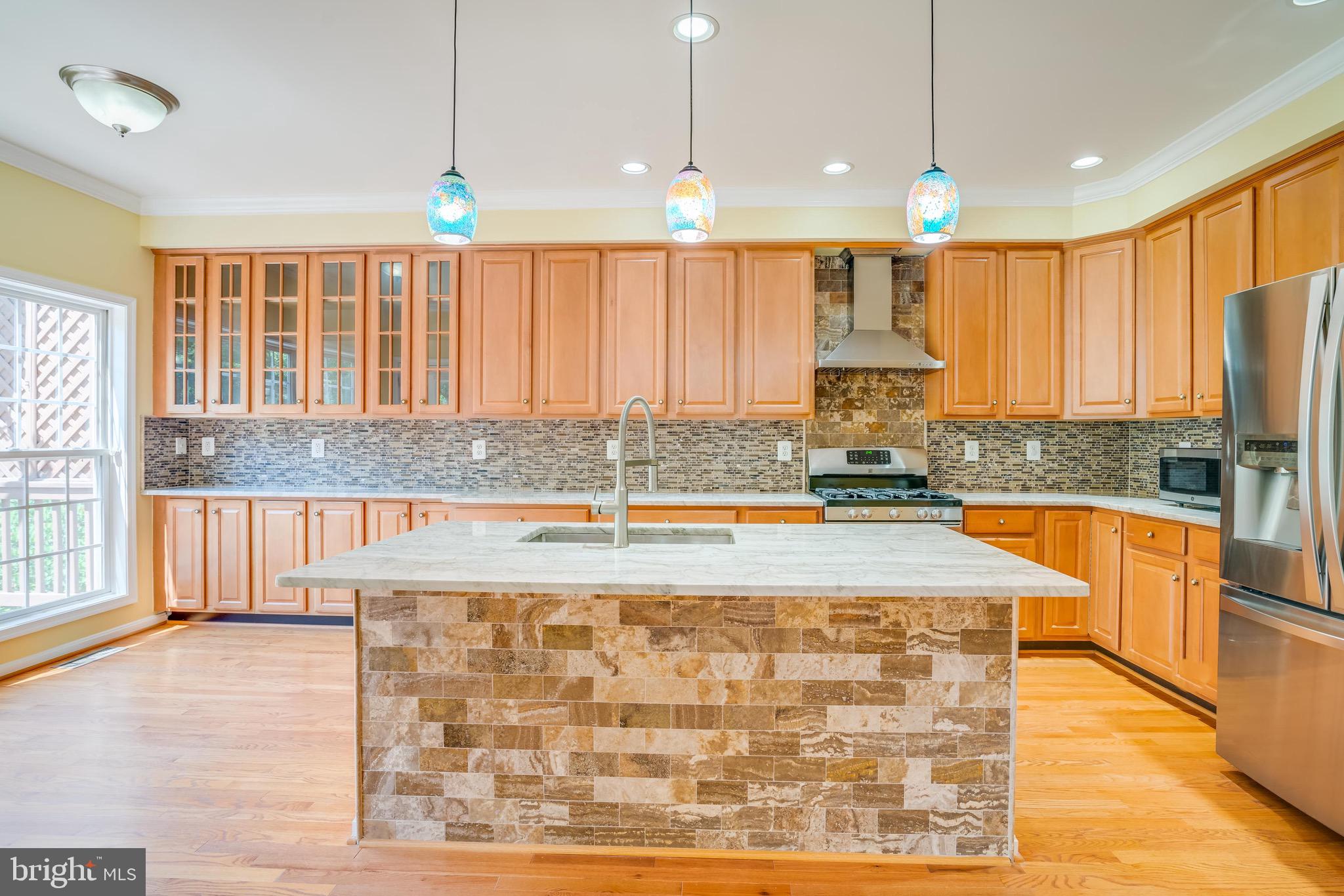 13641 Cedar Run Lane Herndon, VA 20171 - Photo 13 of 56 a large kitchen with kitchen island granite countertop a large window and stainless steel appliances