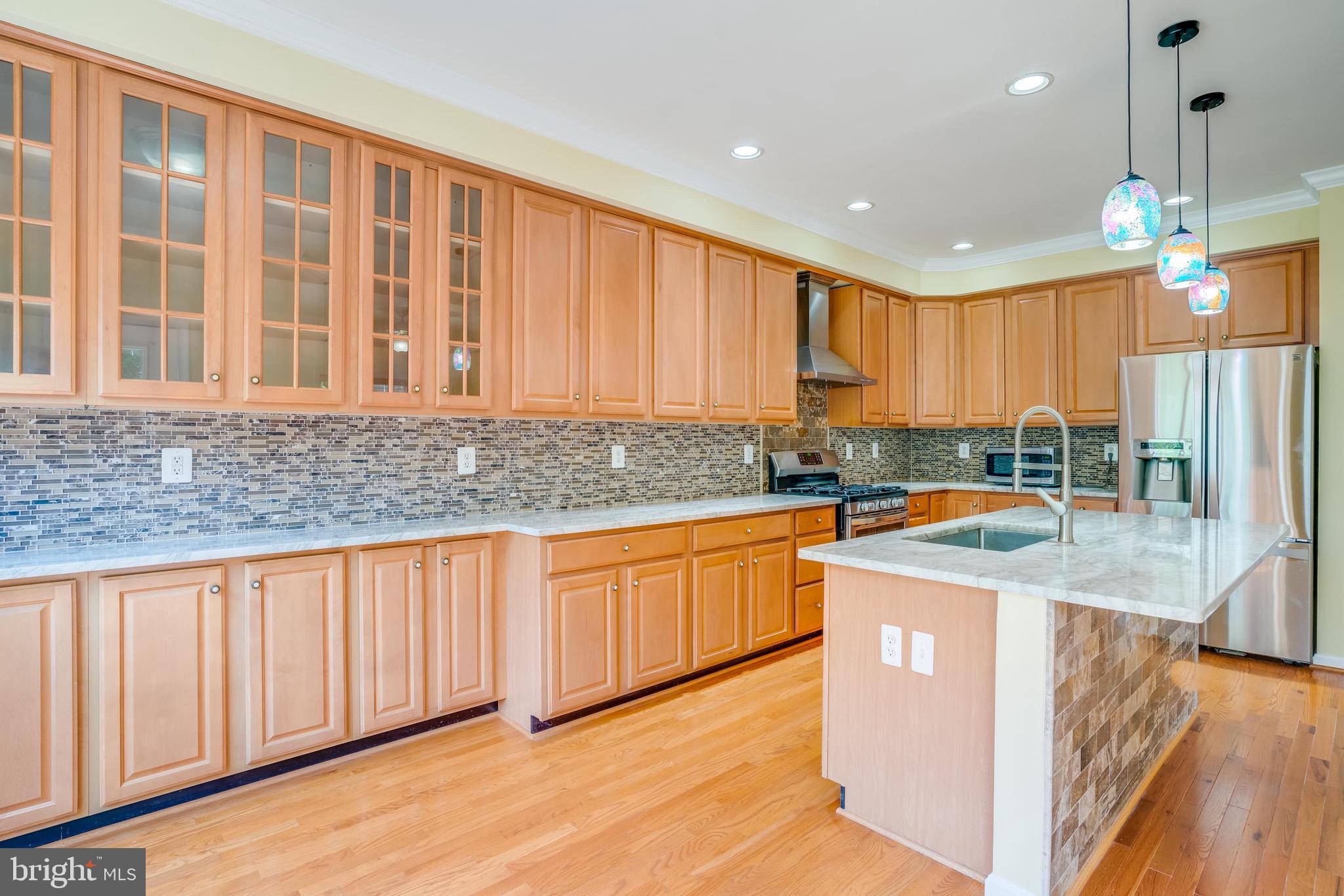13641 Cedar Run Lane Herndon, VA 20171 - Photo 14 of 56 a kitchen with stainless steel appliances granite countertop a sink stove and cabinets