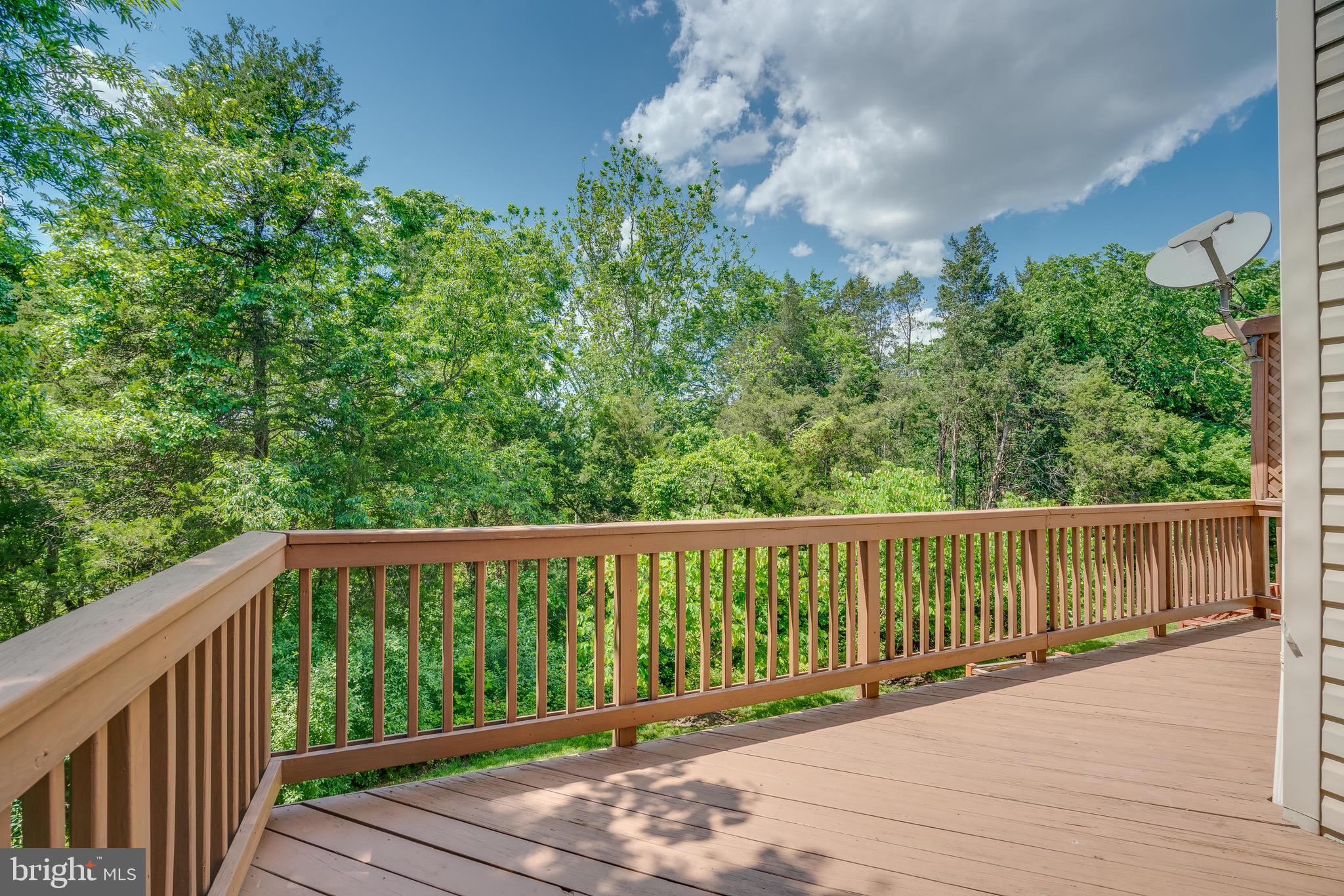 13641 Cedar Run Lane Herndon, VA 20171 - Photo 18 of 56 a view of a wooden deck next to a yard