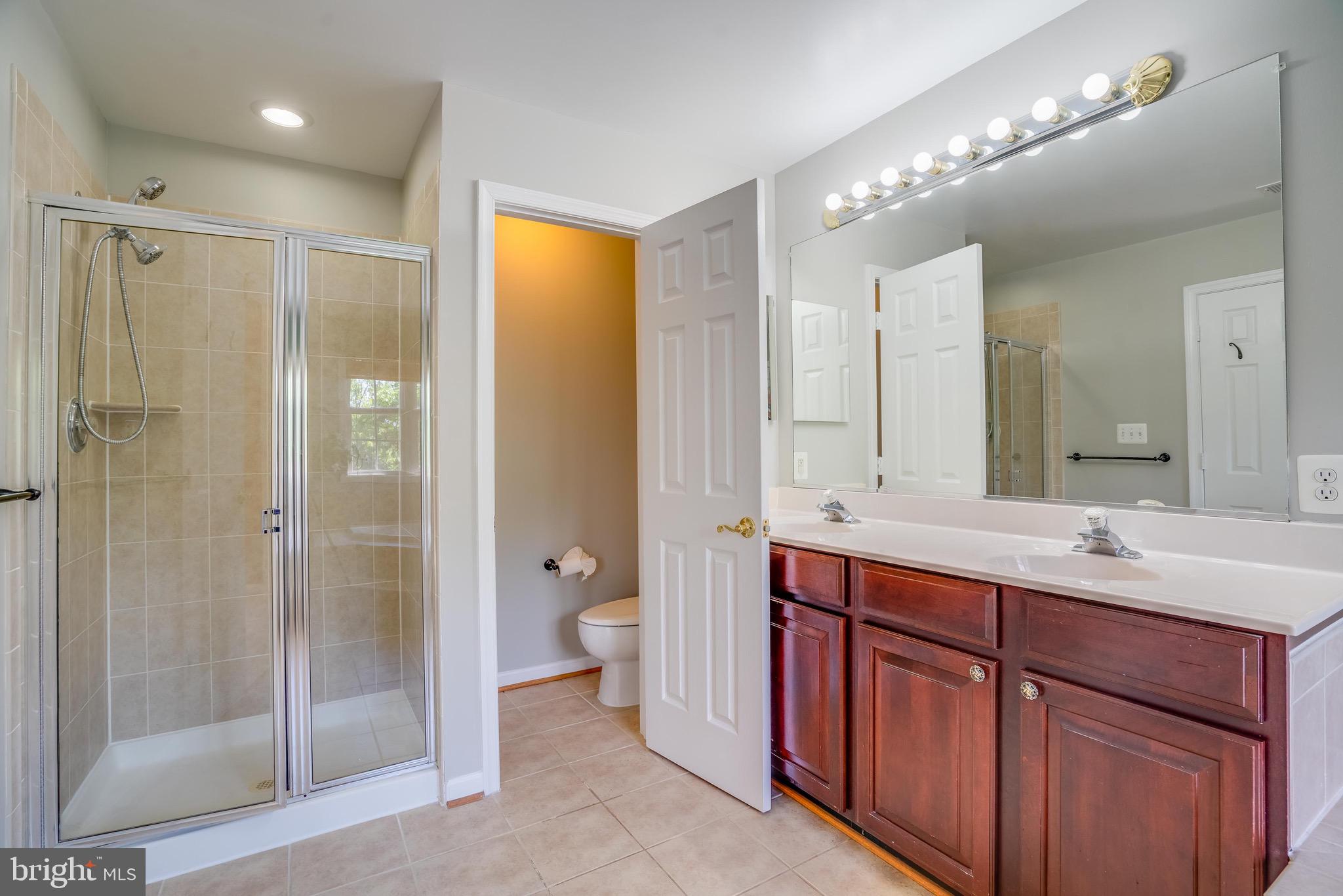 13641 Cedar Run Lane Herndon, VA 20171 - Photo 38 of 56 a bathroom with a double vanity sink mirror double and shower