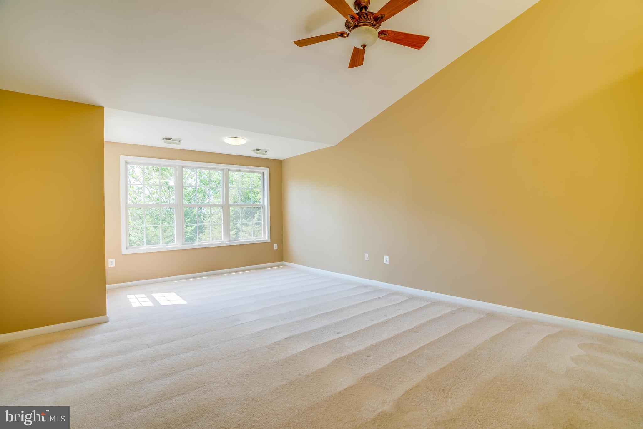 13641 Cedar Run Lane Herndon, VA 20171 - Photo 41 of 56 a view of a big room with wooden floor and chandelier fan