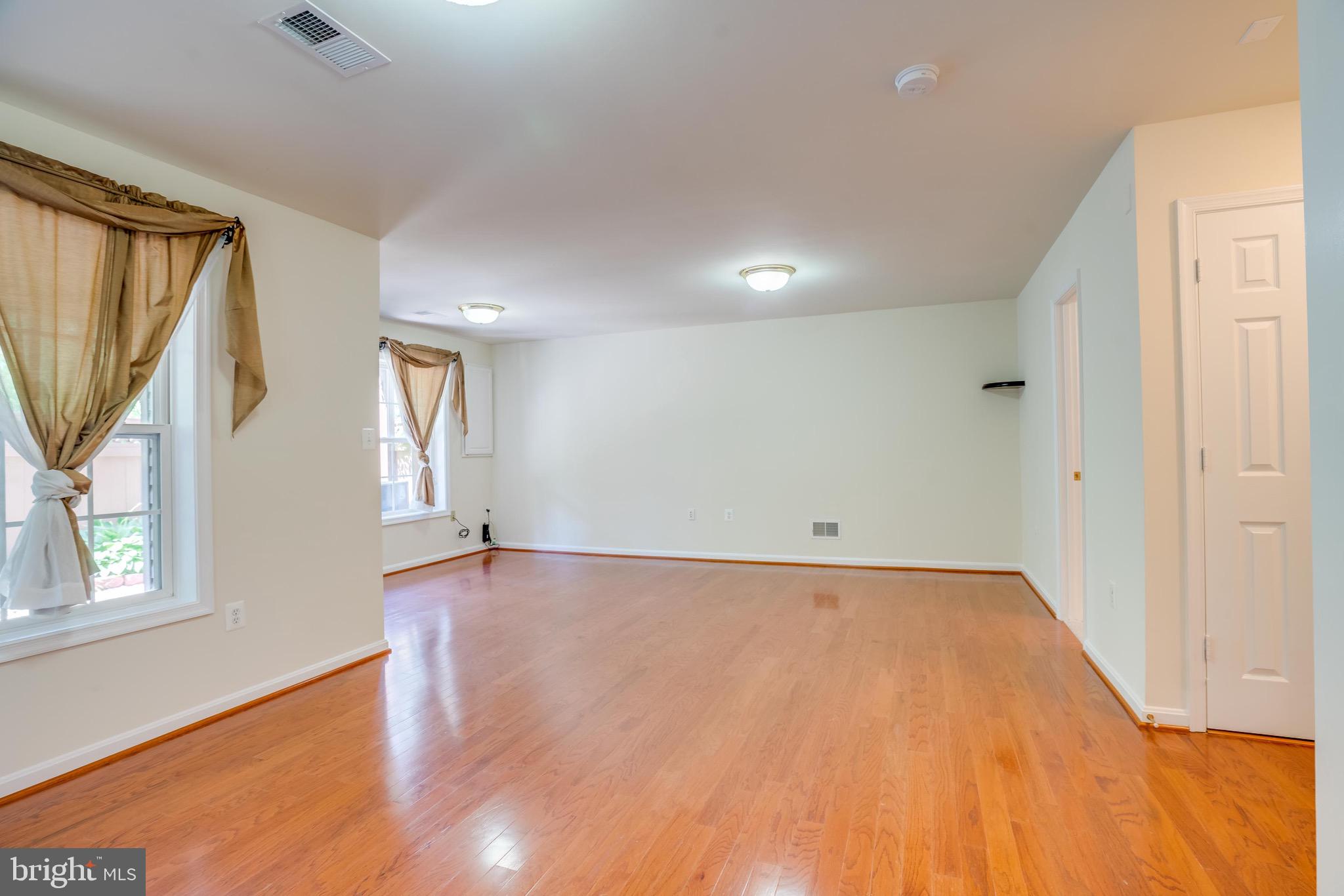 13641 Cedar Run Lane Herndon, VA 20171 - Photo 44 of 56 a view of an empty room with wooden floor and a window