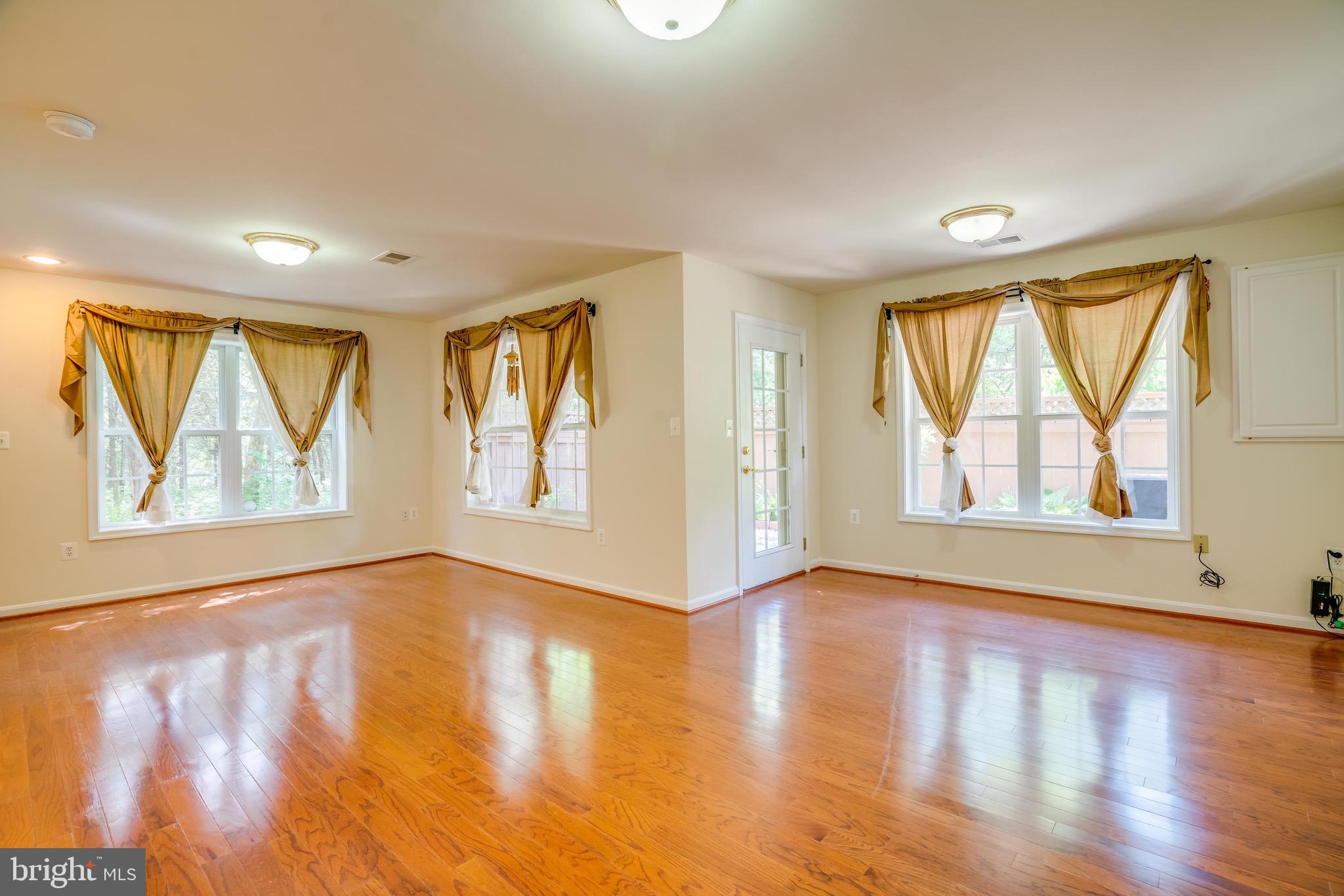 13641 Cedar Run Lane Herndon, VA 20171 - Photo 45 of 56 a view of an empty room with wooden floor and a window