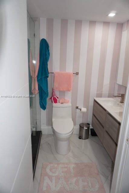 701 Brickell Key Boulevard, Unit 412 Miami, FL 33131 - Photo 15 of 37 a bathroom with a toilet and a shower